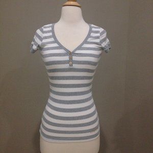 Bebe stretch fitted top with gold embellished logo.